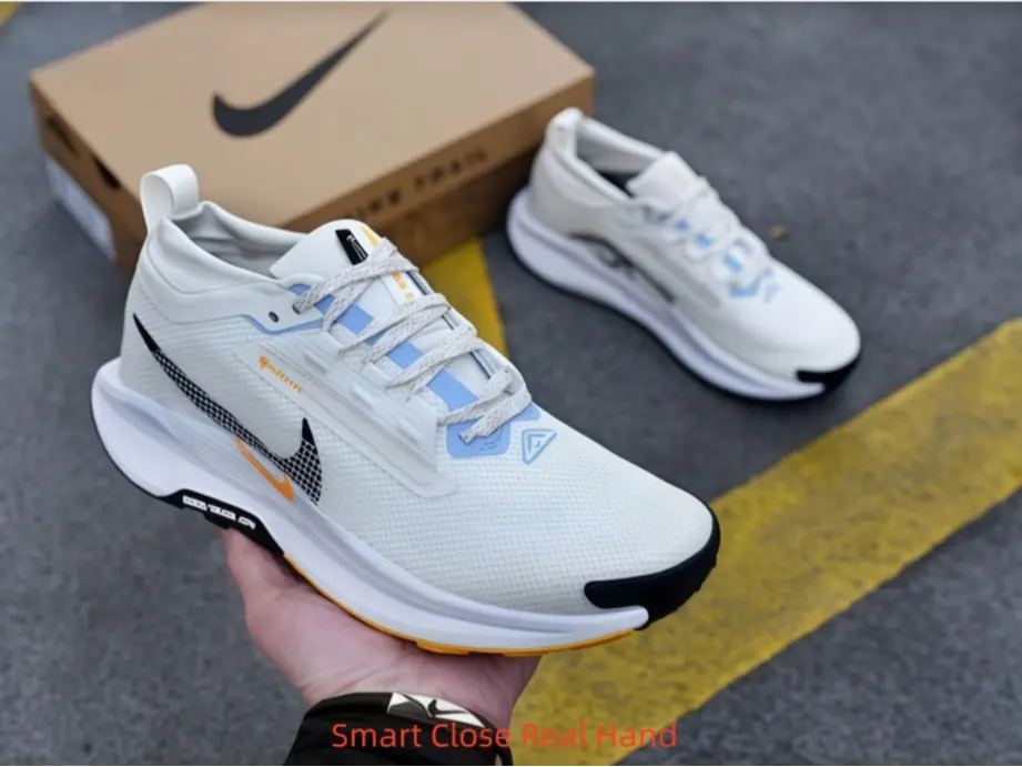 Off-white low-top collectible sneakers, breathable grid mesh upper with light blue & orange geometric accents
