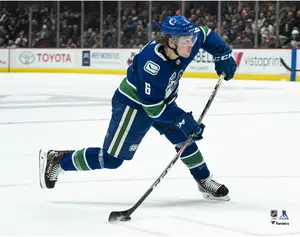 Brock Boeser Vancouver Canucks Unsigned Blue Jersey Shooting Photograph