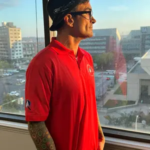 This is a Constitution Art Society large red polo single logo Capitol and brush shirt. This shirt represents the act of bringing America’s artistic talent face to face to their leadership and pay tribute to them with art.