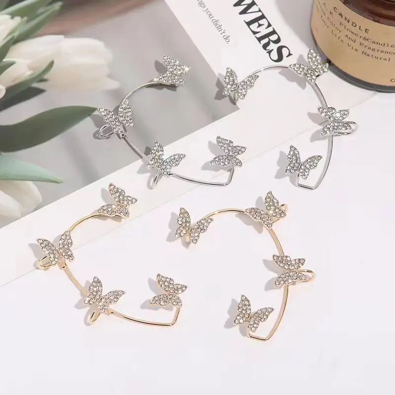 The butterfly ear hangs gold in the righ