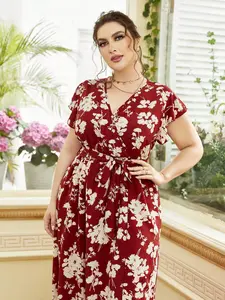 A plus-size women's long dress, Boho Bohemian Casual, with a wine-red base and white floral print, featuring a V-neck and waist-cinching design, suitable for casual social occasions