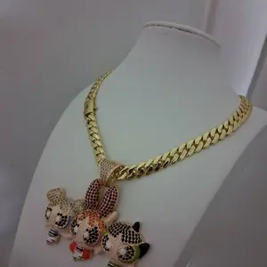 Gold plated chain ,6 millimeters thick 16  inches long with a cartoon pendant featuring three figures