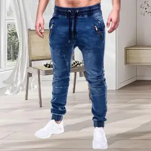 Men’s blue skinny jeans with a self-tie ankle cuff, an elastic drawstring waistband, and zippered pockets; slim-fit and stylish, easy to wear with a sporty, casual look.