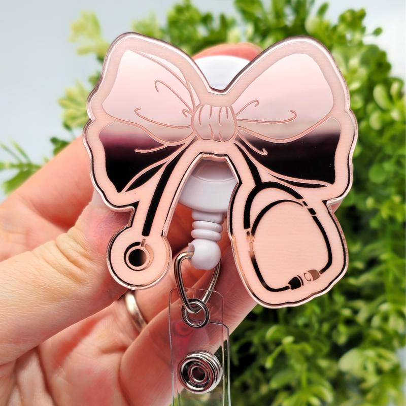 Bow with Stethoscope Badge Reel, Laser Engraved with Smooth Mirror Finish, Funny Badge reel for nurses, xray techs and hospital workers. Retractable swivel clip with a 360 rotation. Great gift for coworker. Cute Badge for Work. Badge clip, Badge pull