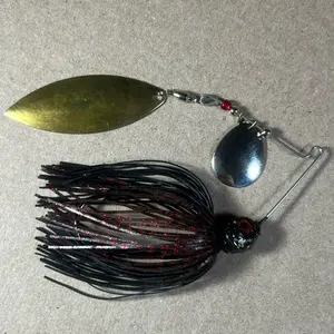 Custom Bingo Spinnerbait, 1/2oz Black Neon & Dark Melon Red Tandem Colorado/Willow Nickel/Gold Blades with 80-Strand Tournament-Grade ProUmbrella Skirt, Brass-Based Premium Components, Hand-Crafted in Texas, USA.