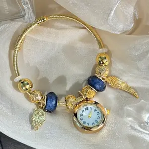 Vintage Charm Bracelet Watch with Owl & Wing Charms, Gold-Tone Twisted Wire, Blue Bead Accents, Adjustable Bangle Style, Round White Dial, Whimsical Bohemian Quartz Wristwatch, Perfect for Casual & Festival Wear, Unique Statement Jewelry