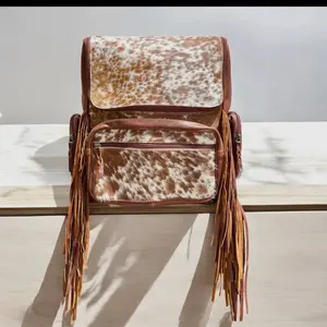 Tan Cowhide Fringe Backpack with Unique Spotted Design and Tassel Details