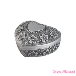 A customizable metal jewelry box, an elegant floral design wedding ring organizer, and a durable metal keepsake organizer, perfect for engagements, anniversaries, and wedding gifts - no electricity required. Exquisitely crafted jewelry box and keepsake or
