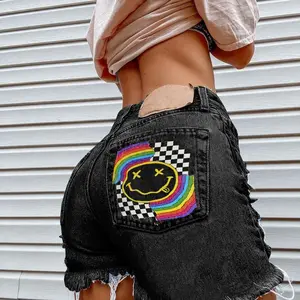 High-waisted rainbow-style denim shorts – ripped jeans with smiley face and plaid patches