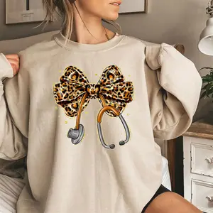[Made in USA] Leopard Nurse Bow Sweatshirt, Cute Stethoscope Nurse Graphic Crewneck Pullover, Trendy Leopard Print Nurse Life Sweatshirt, Aesthetic Nursing Crewneck, Cute Nurse Bow Pullover, Stylish Nurse Outfit, Gift For RN LPN CNA Nursing Student