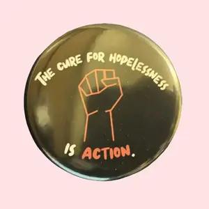 The Cure For Hopelessness is Action. Pinback Button | 2.25 in
