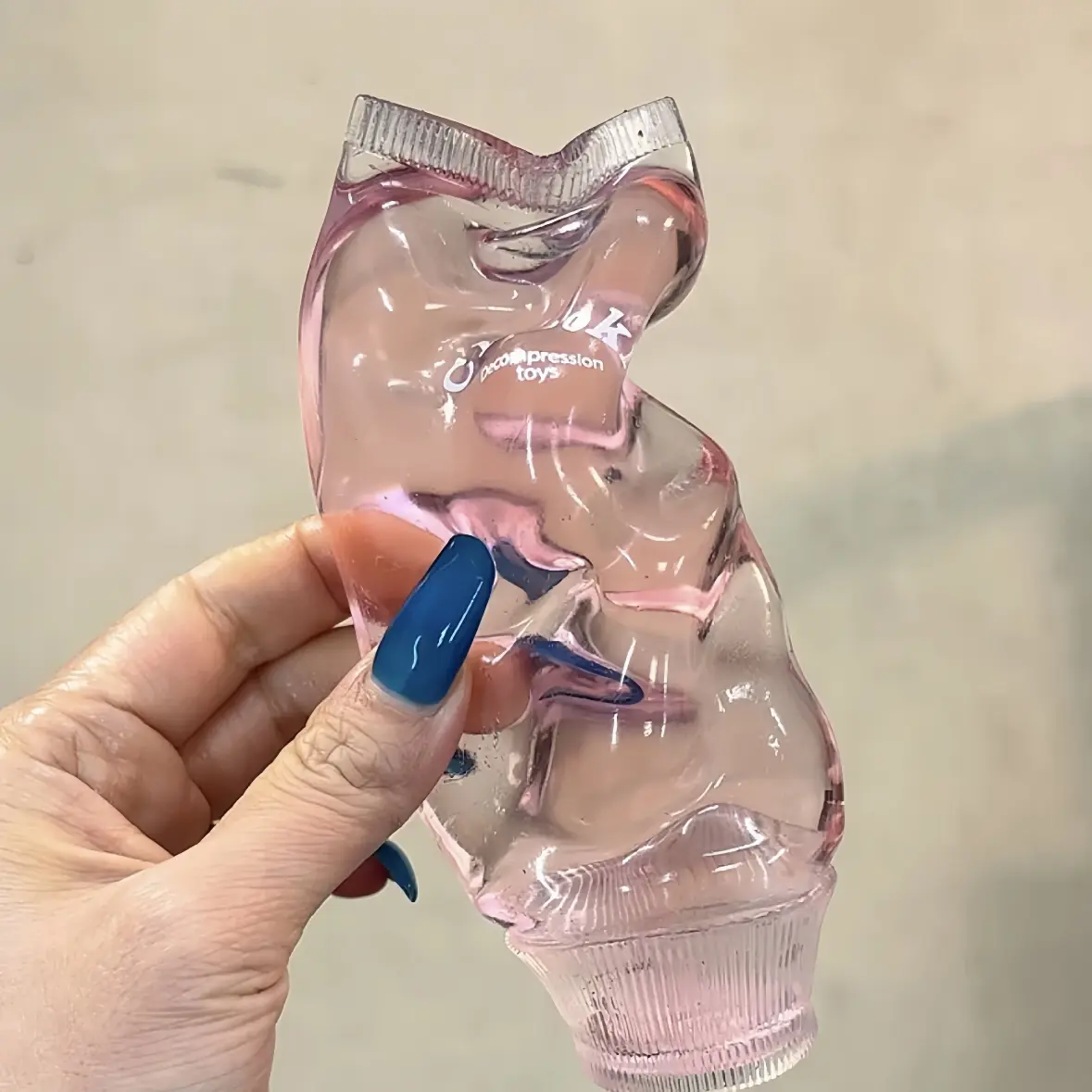 Transparent toothpaste-shaped squeezeable toy, soft to the touch