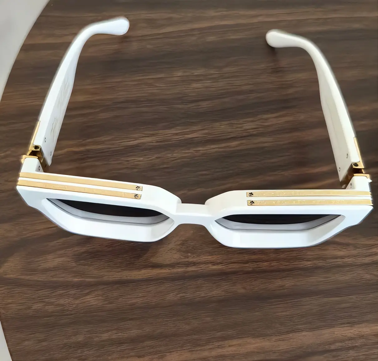 White Sunglasses with Gold Accents and Unique Design