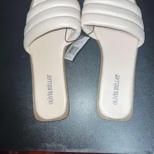 Olivia Miller White Leather Slippers with Comfortable Fit and Elegant Design