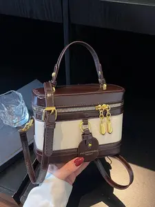 Brown and white color blocked cylindrical bag, Daily commuter purse, niche design light luxury handbag, single shoulder crossbody bag, double zipper design, with bag hanging accessories, suitable for dating, commuting, shopping, Chic crossbody purse
