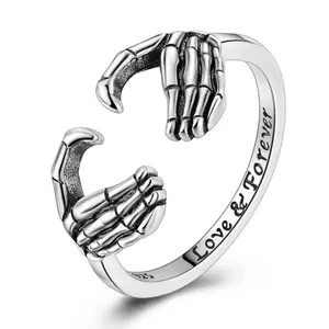 MULA Skull Hand Heart Ring | Punk & Edgy Design with Open Ring | Sterling Silver Skeleton Hands Making a Heart | "Love & Forever" Engraving | Perfect Gift for Bold Fashion Lovers