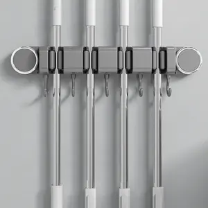 Bathroom suction mop holder for wall mounting, no drilling required. Bathroom door-mounted mop holder with multiple hooks for sweeping. Mop cloth storage rack.