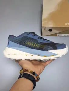 Obsessed with this stylish blue gradient trail running sneaker with yellow accents, lightweight and grippy for outdoor adventures