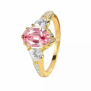 Padparadscha Pink Sapphire Trio Ring in Yellow Gold with Pear Moissanite Accents Sparkle Three-Stone Engagement Ring Yellow Gold Pink Sapphire Oval Firework Cut Diamond Cluster Promise Anniversary Handmade