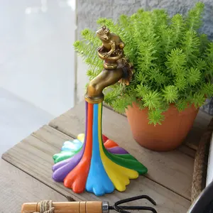 A whimsical rainbow faucet sculpture with a frog - resin garden and courtyard art decoration