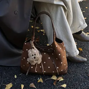 Unique fashion polka dot women's shoulder bag, made of high-quality matte texture fabric that is soft and delicate, showcasing a niche fashion style. The handle is sturdy and durable, allowing for seamless switching between shoulder and hand-carry modes