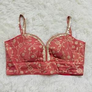 Designer Blouse in Vibrant Coral with Intricate Gold Embroidery and Adjustable Straps for Stylish Comfort