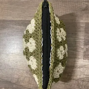 Handmade crochet zip up pouch. Lime green & cream colored makeup bag