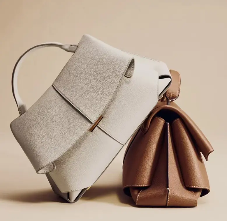 Niche-style women's handbag with a sophisticated, pleated design; suitable for crossbody or handheld use; minimalist urban aesthetic with an adjustable shoulder strap.