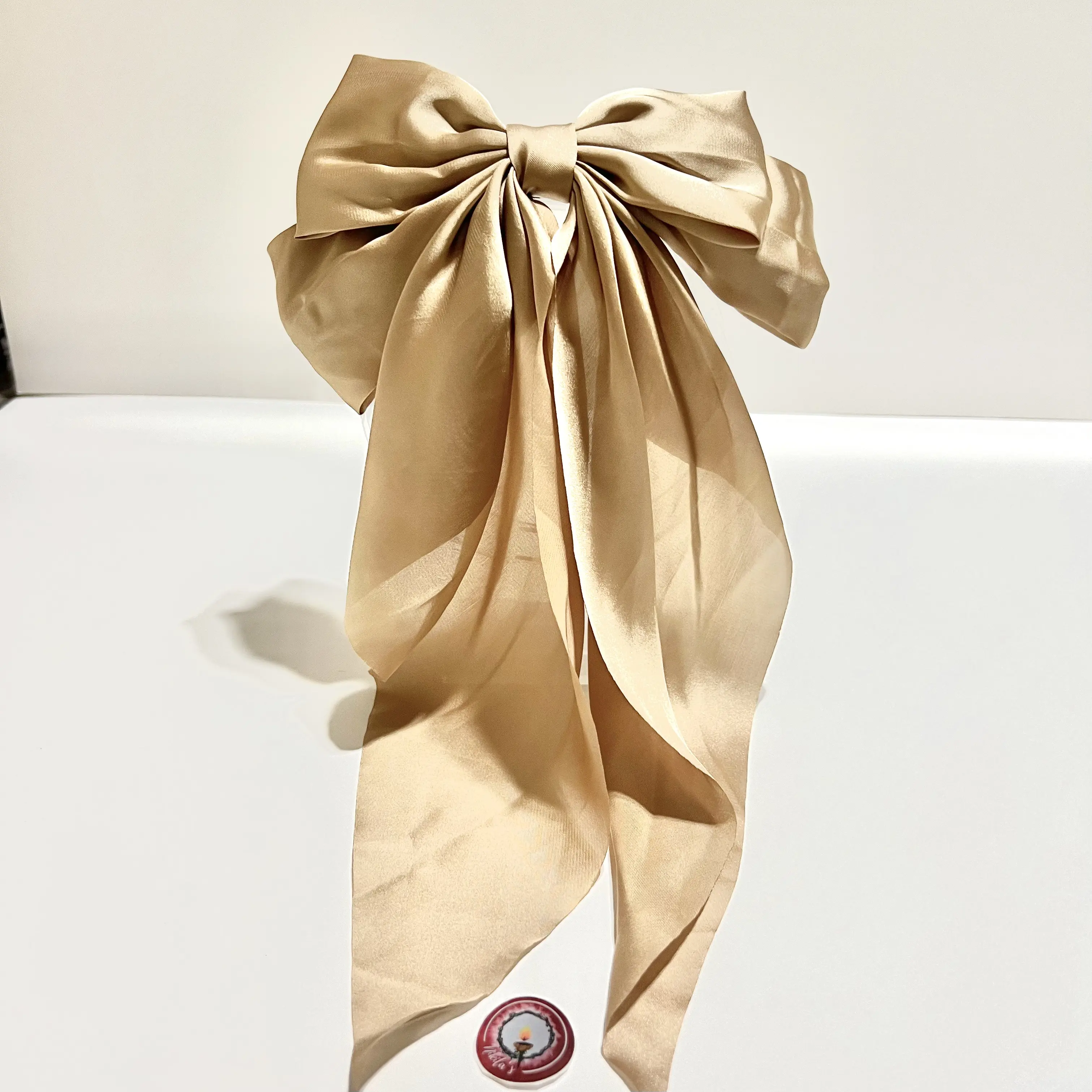 Satin Bow for hair with 3 inches wide French Beret clip attachment in the back. This bow is 16 inches long and 8 inches wide. This hairlip is good for any type of hair texture and length. This is a first quality product