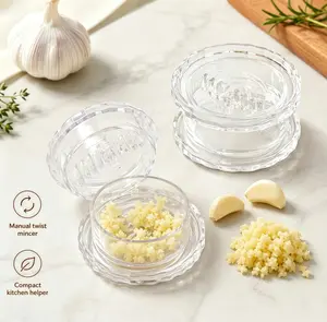 Manual Garlic Press and Chopper—a compact grinder for garlic, ginger, onions, herbs, and nuts; a transparent kitchen prep tool and an everyday household essential