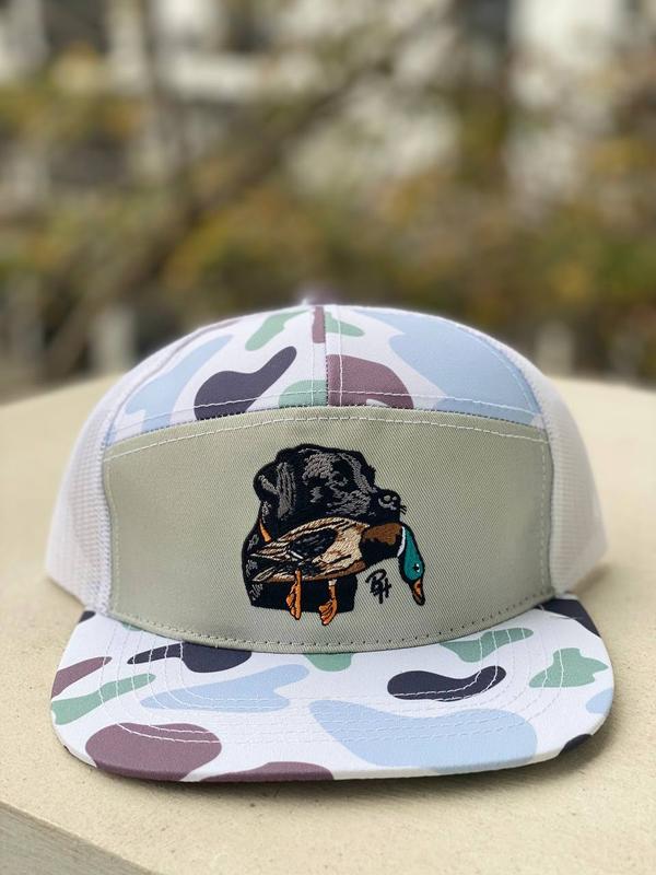 Camo Trucker Hat with Embroidered Black Lab Holding Duck – Mesh Back Hunting Cap, Snapback Adjustable, Waterfowl Retriever Dog Design for Outdoorsmen