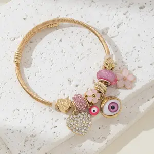 Charming Pink Beaded Bracelet with Devil's Eye Rhinestone Love Flower Charms Elegant Fashion Accessory Gold-Toned Wire Perfect Gift