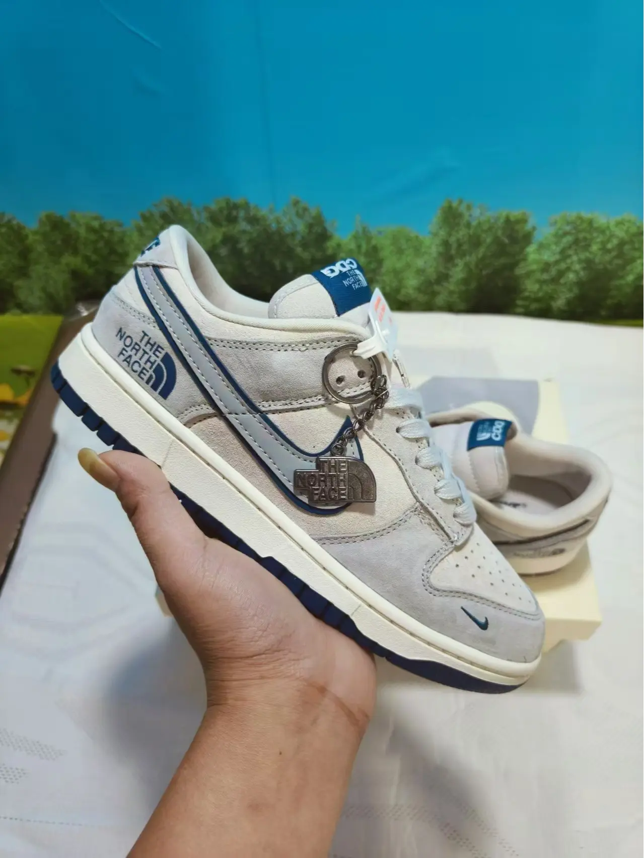 Vintage skate shoes blending plush suede and woven fabric construction, gentle cream base with striking deep navy‑blue highlights, perforated toe box, must‑have for classic retro modern street fashion aesthetic.