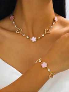 Four-leaf Clover Crystal Jewelry Set | Gold-plated three-color necklace and bracelet, timeless elegance. This Four-leaf Clover set features enamel pieces in black, pink, and white, adorned with sparkling crystals, effortlessly enhancing the texture of any