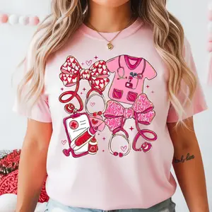 Pink Valentine Nurse T-Shirt for Women, Cute Coquette Nurse Shirt with Stethoscope Bow, Heart & Scrubs Design, Valentine’s Day Gift for Nurses, RN, LPN, Nursing Students, Medical Staff Graphic Tee