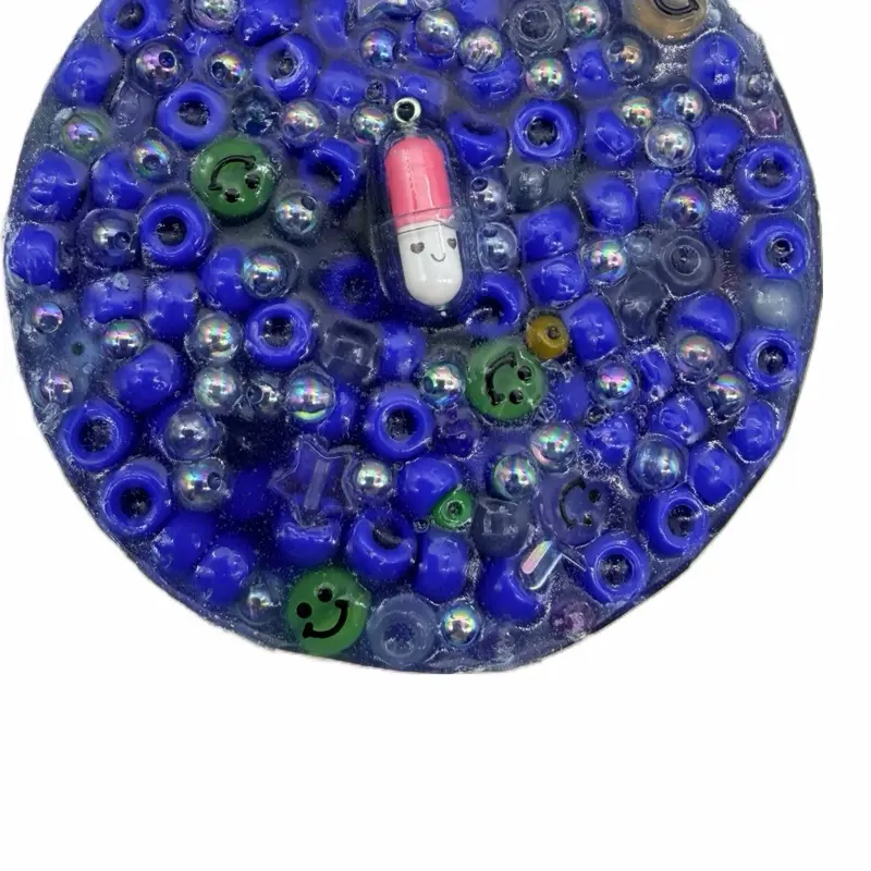 The Wiley Merchant 6oz Reusable 30x  Mamas Happy Picky Pad W/Glow in the dark Smiley beads and blue pony beads.