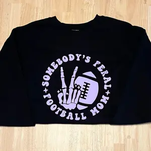 Women’s long sleeve crewneck pullover hoodie sweatshirt somebody’s feral football mom graphic design Womenswear Tops Casual