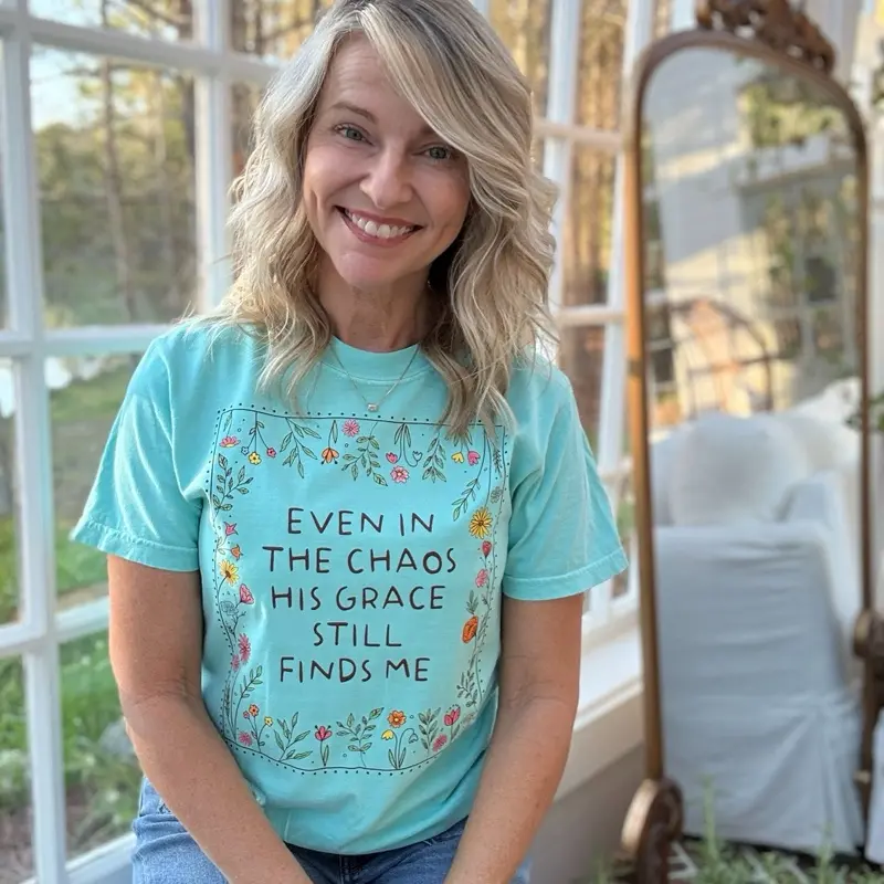 Even in the chaos His grace still finds me. Mint comfort color tee with all the colors surrounding such a sweet message. Floral Design tee.
