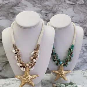 Melina chunky starfish & seashell stamens necklace featuring gold-plated starfish pendant on braided rope.