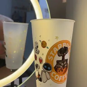 Starbucks 27oz Plastic Cup with Yellow Wrap Featuring Cartoon Characters and Space Theme Design