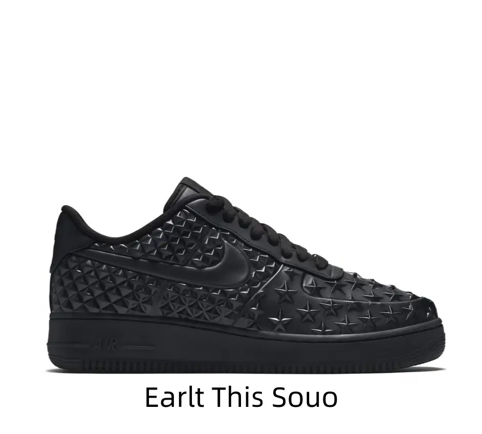 Clean minimalist all-black leather low-top athletic footwear with dense 3D star and triangle embossment covering the whole upper, full matching black rubber outsole with subtle engraved letter detail