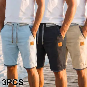 Men’s summer casual shorts—mid-length shorts for men; trendy patchwork shorts with an elastic waistband, mixed colors and drawstring, side stripes with piping, and a leather brand label decoration. Effortlessly conveys a relaxed vacation vibe, suitable fo