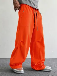 Men’s high-waisted baggy pants, orange, casual loose fit athletic trousers with deep pockets for urban street style