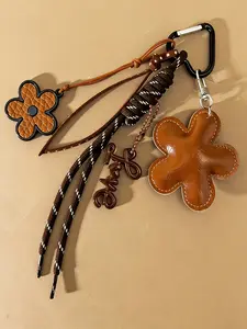 Leather Flower Bag Charm Retro Brown Woven Hanging Ornament Leather Flower + Letter + Braided Cord Combination Stylish And Versatile Sophisticated Accessories Fashion Bag Charms Multi-Pendant Combination For Bags, Keys, And Earphones