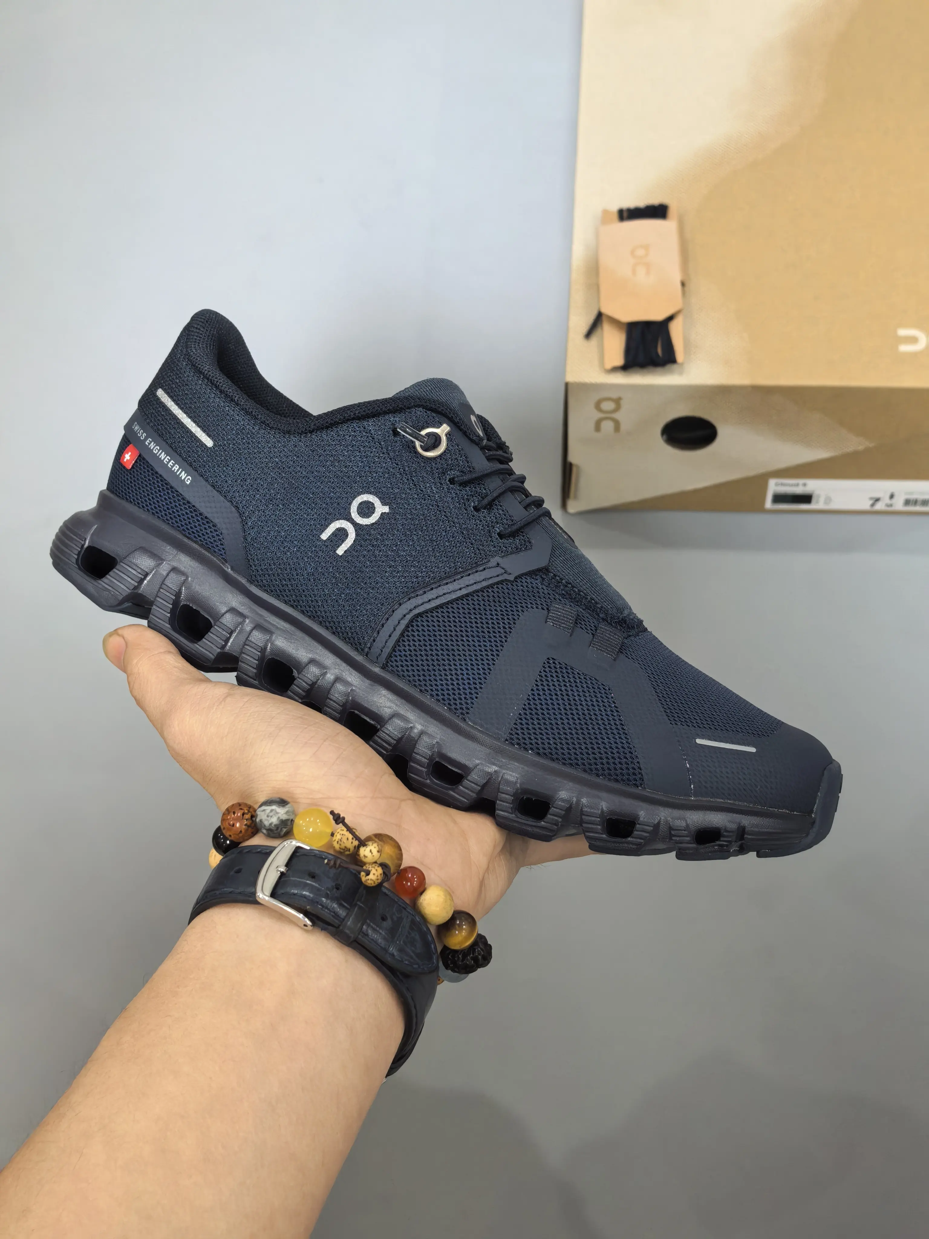 Deep navy breathable woven mesh unisex running sneakers, hollow rugged dark foam midsole, faint silver reflective side strip accents, fit for city jogging mall strolls daily office commutes