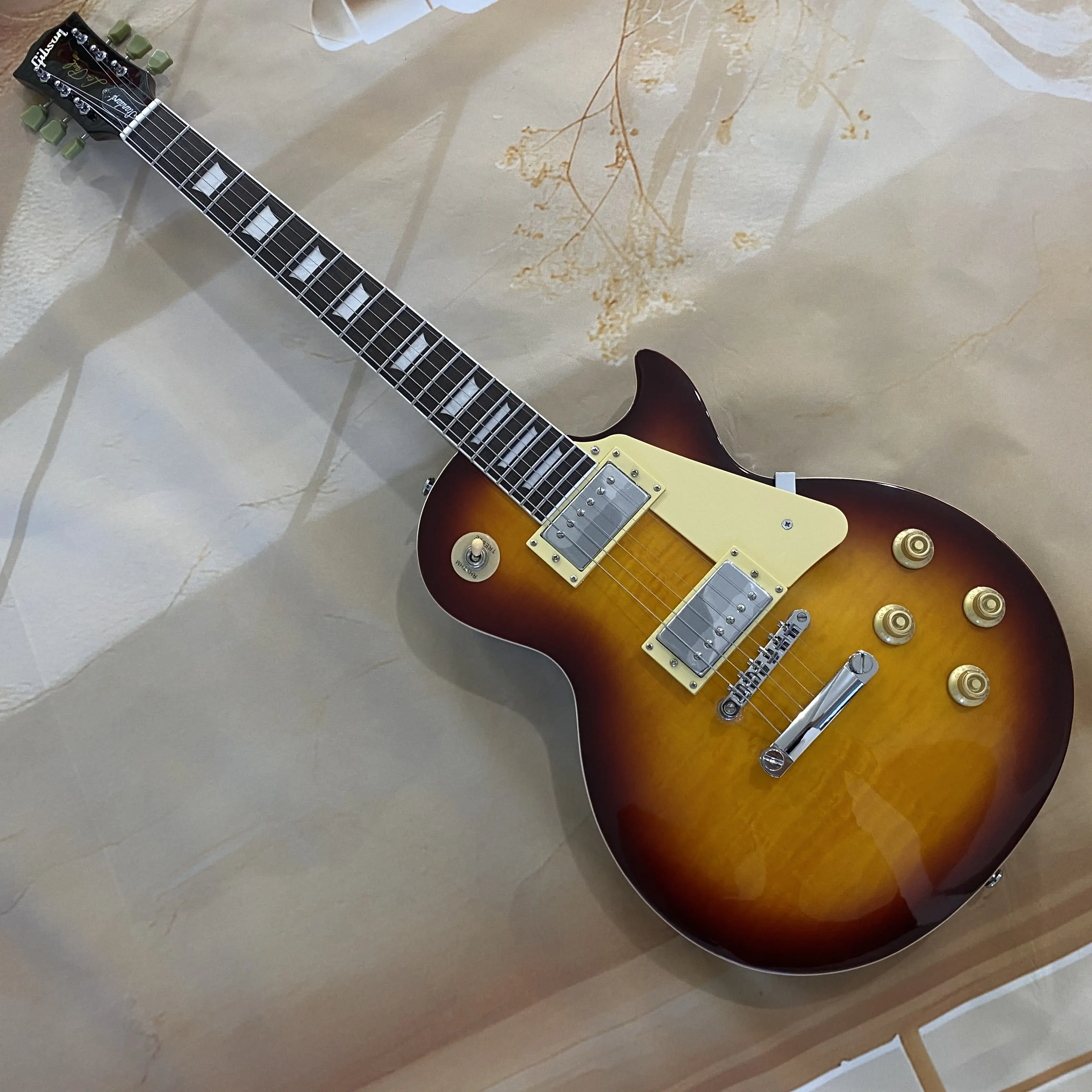 LP electric guitar, flame maple top, equipped with dual pickups, chrome hardware, cream-colored protective plate, ships immediately