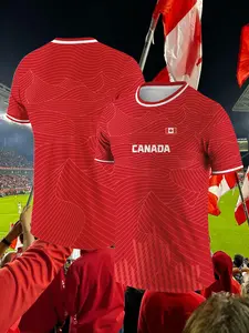 Canada Red Classic Soccer Jersey T-Shirt Features a wavy line pattern design with red and white striped trim Lightweight and flexible four-way stretch construction