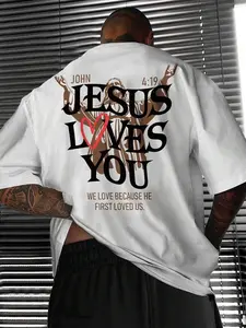 Jesus Loves You" John 4:19 Christian Bible Verse Graphic T-Shirt, Faith Quote Print Oversized Crew Neck Tee, Men's Short Sleeve Religious Cotton Top, Trendy Spiritual Aesthetic Shirt for Believers, Bible Fans and Streetwear Enthusiasts