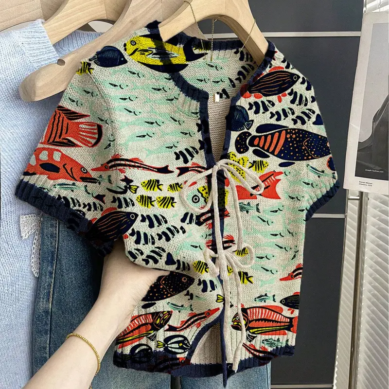 Women's khaki bohemian style vacation ethnic short-sleeve knit top. Loose round neck, contrast patchwork fish print, front tie design, contrast piping. Comfortable for spring & summer casual wear. Casual Classy Top Womenswear Lady Bohemian Inspired