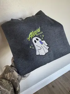 Cute ghost drinking alani. Alani Boo is a cute must have for the holiday season. Embroidered sweatshirt or t-shirt.